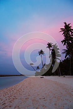 Colorful sunset over beach in Maldives