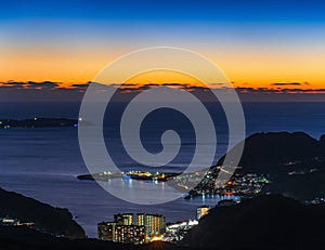 Colorful sunset sky above a seascape of Kyushu from the observation deck of mount Inasa.