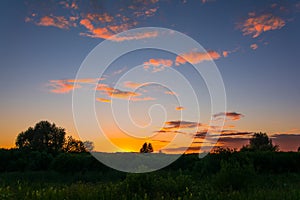 Colorful sunset sky over fields