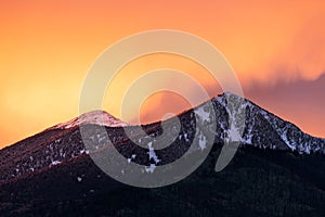 Colorful sunset sky over snow capped mountains in Flagstaff, Arizona.