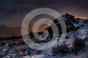 Colorful sunset in the winter forest. Beautiful winter landscape in the mountains. Sunrise.