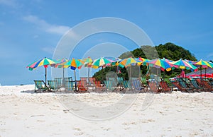 Colorful sunshade and chairs on beach