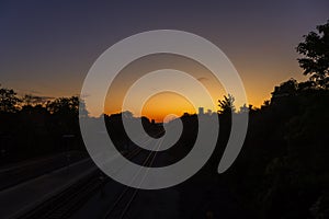 A colorful sunup above a small train station photo