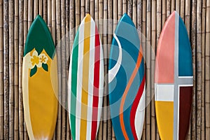 colorful surfboards on bamboo wooden wall