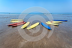 Colorful surfboards on a tidal beach