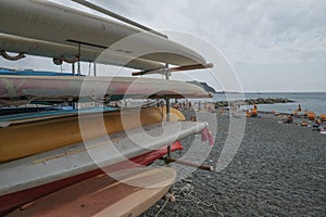 Colorful surfboats folded close-up on the beach. Outdoor activities. Aquatics, water sport equipment