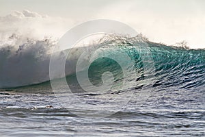 Colorful Surfing Wave Lit with sunlight in Pacific Ocean