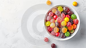 Colorful sweet candies in bowl on white table