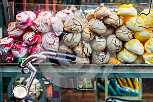 Colorful sweet meringues at roadside confectionery shop. S