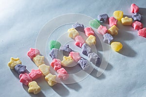 Colorful sweets varied with the word "Happy" written,light blue background,children's concept and joy