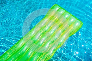 Colorful swim ring or rubber float around swimming pool water