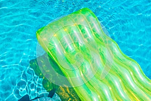 Colorful swim ring or rubber float around swimming pool water