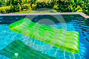 Colorful swim ring or rubber float around swimming pool water