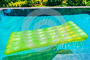 Colorful swim ring or rubber float around swimming pool water