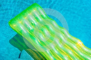 Colorful swim ring or rubber float around swimming pool water