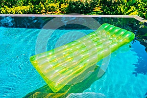 Colorful swim ring or rubber float around swimming pool water