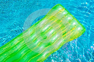 Colorful swim ring or rubber float around swimming pool water