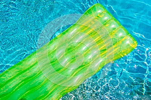 Colorful swim ring or rubber float around swimming pool water