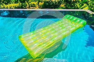 Colorful swim ring or rubber float around swimming pool water