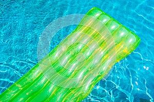 Colorful swim ring or rubber float around swimming pool water