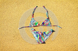 Colorful swimsuit on the golden sandy beach