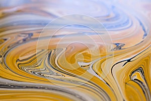 Colorful swirls of ochre paint. Abstract background