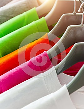 Colorful t-shirt on hangers