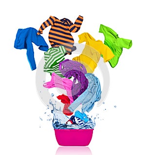 Colorful T-shirts flies out of the laundry bowl