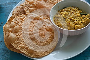 Colorful table with Indian food for breakfast. Papadum bread and vegetarian dal made from lentils or beans.