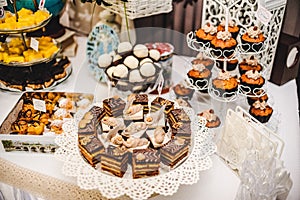 Colorful table with sweets and goodies for the wedding.party reception, decorated dessert table.Delicious sweets on candy buffet.