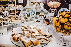 Colorful table with sweets and goodies for the wedding.party reception, decorated dessert table.Delicious sweets on candy buffet.