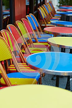 Colorful tables and chairs of outdoor cafe in Paris