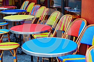 Colorful tables and chairs of outdoor cafe in Paris