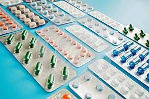 Colorful of tablets and capsules pill in blister packaging arranged with beautiful pattern with flare light