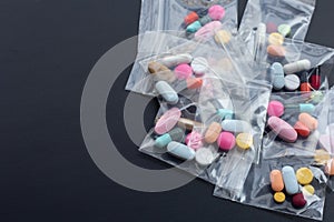 Colorful tablets with capsules and pills in medicine plastic zip lock bags