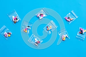 Colorful tablets with capsules and pills in medicine plastic zip lock bags