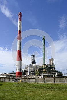 Colorful tall pipes, gas pipelines, tanks, ladders and other equipment for oil refining on the factory