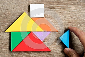 Colorful tangram puzzle in home shape wait for fulfill