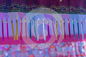 Colorful tassels with Trim on Fabric.