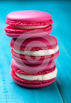 Colorful and tasty cookies macarons on a wooden