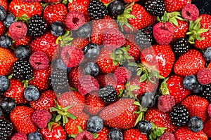 Colorful tasty mix of wild forest berry fruits. Strawberry blueberry raspberry and blackberry. healthy eating nutrition vegan food photo