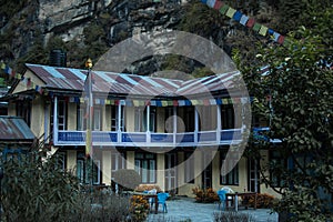 Colorful tea house lodge with prayer flags in Dharapani