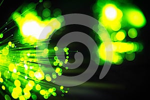 Colorful technological background of optical fibre with bokeh. Abstract IT background. Fiber optic ends closeup. Slightly blurred