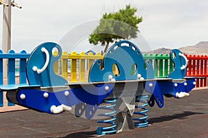 Colorful teeter totter on playground in Las Palmas city