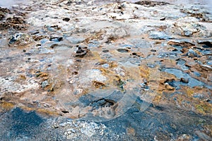 Colorful and textured volcanic ground in geothermal area in Icelandic landscape scenery.
