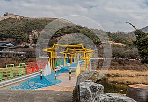 Colorful theme pedestrian bridge over small river