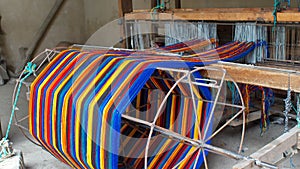 Colorful thread on a loom photo