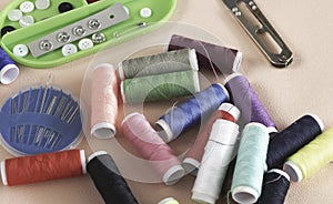 Colorful thread and needle work put on background