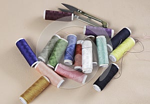 Colorful thread and needle work put on background