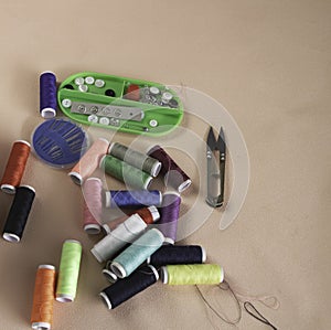 Colorful thread and needle work put on background
